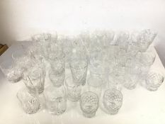An assortment of crystal and glass including wine glasses, sherry glasses, lowballs, whisky