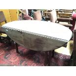 A 19thc bleached mahogany oval drop leaf gateleg dining table raised on square moulded supports (top