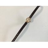 A 9ct gold lady's Sekonda wristwatch with manual movement, on brown leather strap (8.79g)