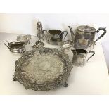 An Epns footed tray with fruit and leaf decoration, a teapot, milk jug and sugar bowl, with