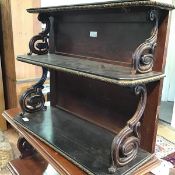 A 19thc rosewood and ebony brass mounted three tier wall shelf, with brass mounted top and S