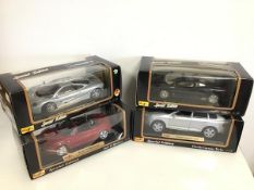 Maisto diecast model cars including a Jaguar, Porsche, Audi and McLaren, all in original boxes