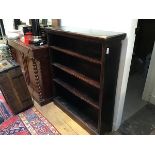 An Edwardian stained pine upright open bookcase fitted three adjustable shelves, raised on plinth
