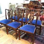 A set of six reproduction mahogany George III style pierced splat back dining chairs, with slip in