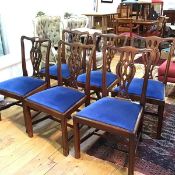 A set of six reproduction mahogany George III style pierced splat back dining chairs, with slip in