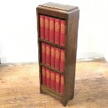 A 1920s oak bookcase, containing a set of Dickins novels, The Waverley Book Co. Ltd. London, with
