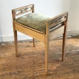 An Edwardian bleached ash box top piano stool with pierced handles to side, raised on square tapered