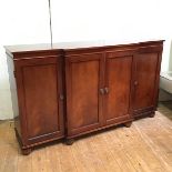 A Regency style mahogany breakfront credenza, the rectangular top above four panel doors, raised