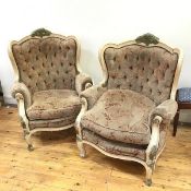 A pair of early 20thc Louis XV style bergere chairs with worn foliate upholstery and button backs (