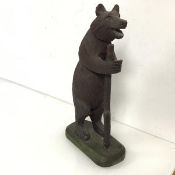 A wooden carved figure of a Bear with a Log (30cm x 15cm x 8cm)