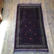 A Persian prayer rug, the shaped centre panel with diamond and flowerhead interior, enclosed