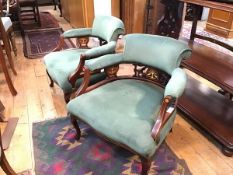A pair of Edwardian mahogany inlaid horseshoe back tub chairs, with upholstered back, arms and seat,
