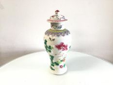 A 19thc Chinese famille rose baluster vase and cover decorated with peony and chrysanthemum