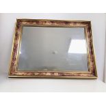A modern wall mirror with gilt and painted frame