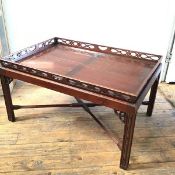 A Chippendale inspired mahogany coffee table with lift out pierced galleried tray top, the stand