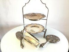 An Epns two tier cakestand, a three piece white metal chased Art Nouveau style dressing table