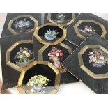 A set of eight handpainted black muslin panels with gilt threaded borders, with handpainted vases of