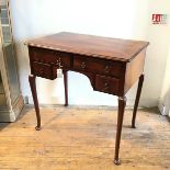 An Edwardian mahogany lowboy, the rectangular top with crossbanded border and moulded edge above two