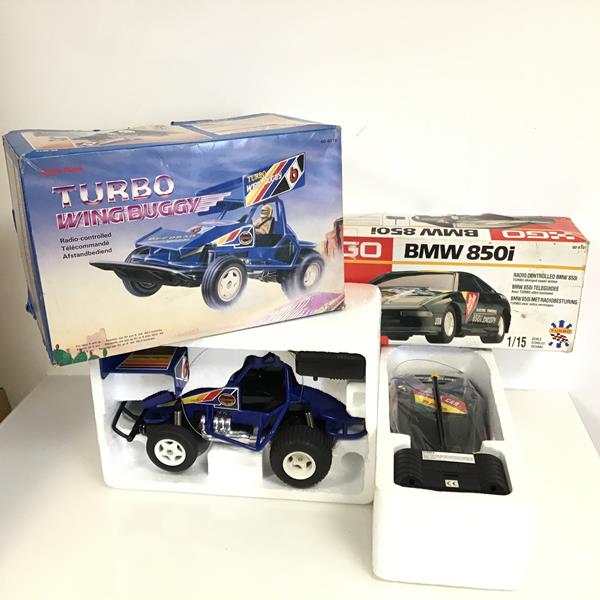 A Radio Shack Turbo wing buggy radio controlled car and a Go BMW radio controlled car, both with