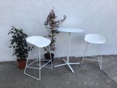 An Andreu World modern pedestal table with white opaque glass circular top together with two high