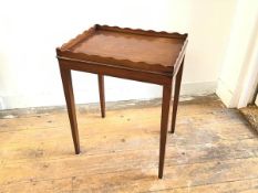 A mahogany occasional table with scalloped tray top and plain frieze, raised on square tapered
