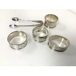 A collection of silver napkin rings and a pair of sugar nips (combined: 107.17g)