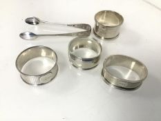 A collection of silver napkin rings and a pair of sugar nips (combined: 107.17g)