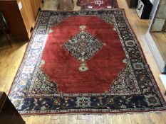 A 1920s North Persian rug, the centre diamond shaped medallion with enclosed lotus flower and leaf