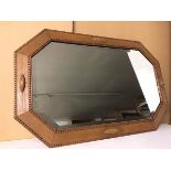 An octagonal wall mirror with bevelled glass, the frame with beaded edges (54cm x 85cm)
