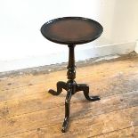 A mahogany and beech stained pedestal wine table, the circular top with moulded edge on turned