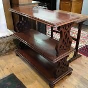 A Victorian mahogany three tier bookstand, the rectangular top with moulded edge raised on pierced