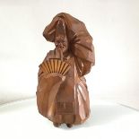 A carved pine figure of a Japanese Immortal with removeable fan, two character marks verso (h.29cm)