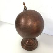 A metal terrestrial globe on stand, naively engraved (36cm x 24cm)