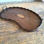 An Edwardian mahogany kidney shaped inlaid two handled tea tray, with scalloped border (57cm x