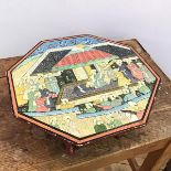 A low Persian table, the octagonal top painted with a princely scene, on folding supports (12cm x