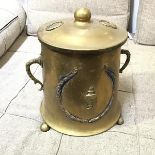 A brass circular coal scuttle of Neoclassical design, on three ball feet (39cm x 39cm x 30cm)