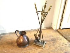 A 19thc style brass companion set stand with a set of three urn shaped brass mounted fire irons