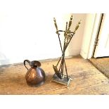 A 19thc style brass companion set stand with a set of three urn shaped brass mounted fire irons