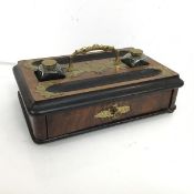 A Victorian mahogany inkstand, with brass mounts includes two glass ink bottles, fitted single