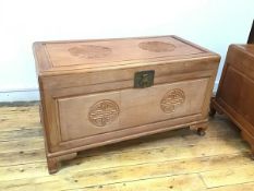 A Chinese camphorwood chest, with moulded top and front, the hinged top over a plain interior (