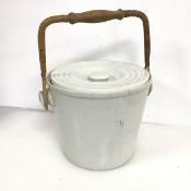A ceramic lidded slop pail with cane and wooden handle (24cm not including handle x 32cm)
