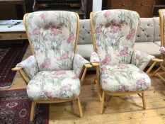 A pair of Ercol light ash armchairs with floral upholstery, stamped Ercol to base (103cm x 78cm x