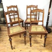 A set of four late 19thc French fruitwood side chairs, with cane seats on turned front supports (