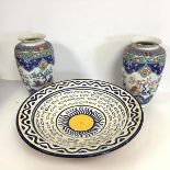 A large glazed terracotta bowl with wave and fish decoration, signed C.A.P.S. (9cm x 42cm) and a