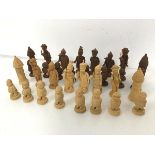 A set of Nigerian hand carved wooden chess pieces, some losses (tallest: 9cm)
