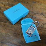 A Tiffany keyring mounted with plane and globe design, in original box and felt bag (7cm x 2.5cm)