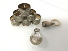 A Birmingham silver caddy spoon with shell motif (8cm x 4cm) (20.82g), an Edwardian teething ring