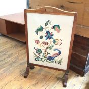 A 1930s oak framed firescreen, with embroidered panel depicting flowers, leaves and birds (80cm x