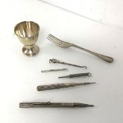 A Victorian London silver fork, an Edwardian Birmingham silver egg cup (combined: 58.54g),