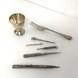 A Victorian London silver fork, an Edwardian Birmingham silver egg cup (combined: 58.54g),